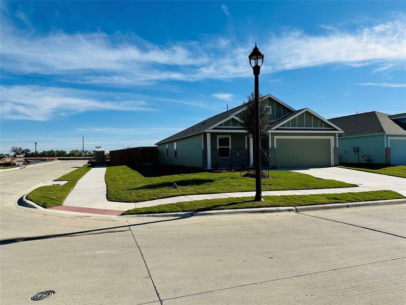 View of front of home with a front yard and a garage