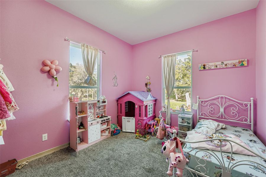 Carpeted bedroom with baseboards Carpeted bedroom with baseboards