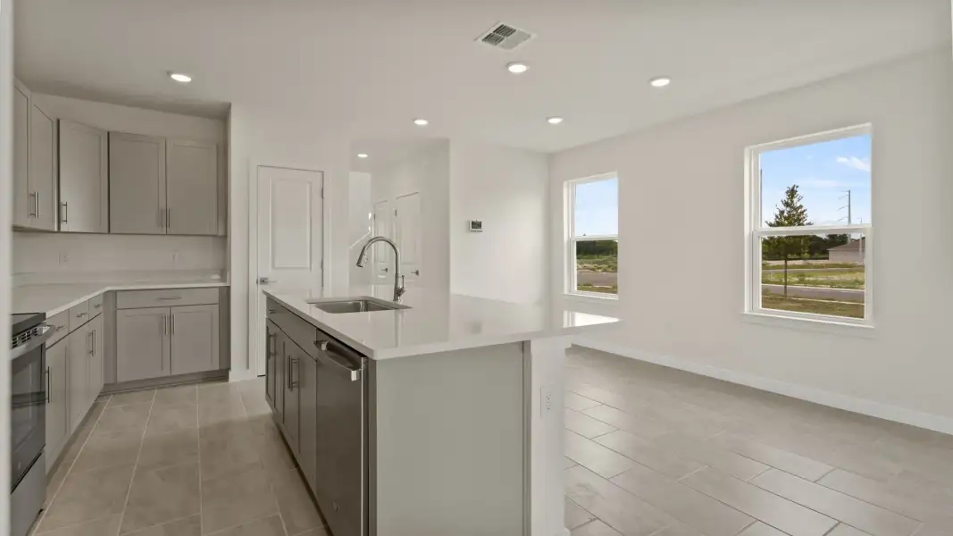 The Naples Kitchen with large Island Quick Move-In Home at Willowbrook North by DRB Homes in Winter Haven, FL