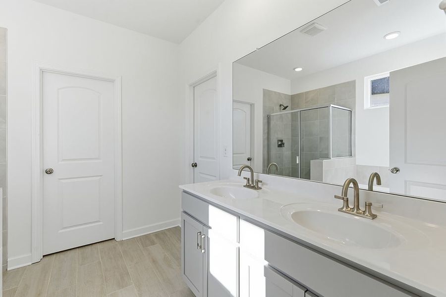 A bathroom with a large mirror.