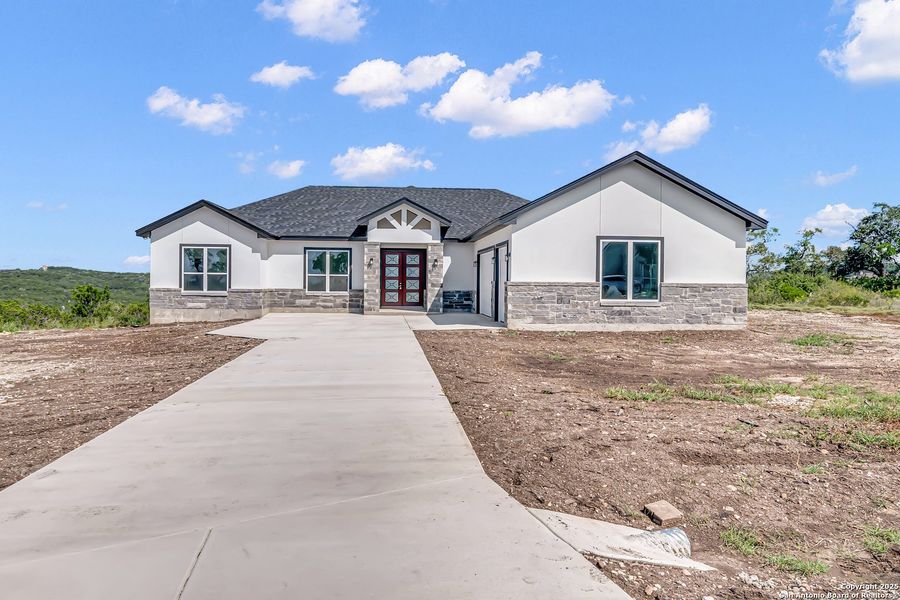 Front exterior of a new home in , Mico, TX, highlighting curb appeal (Image 1). Front exterior of a new home in , Mico, TX, highlighting curb appeal (Image 1).
