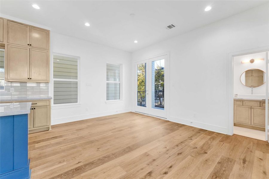 The dining area with views of the balcony. You can also see the half bathroom on the right side of this photo.