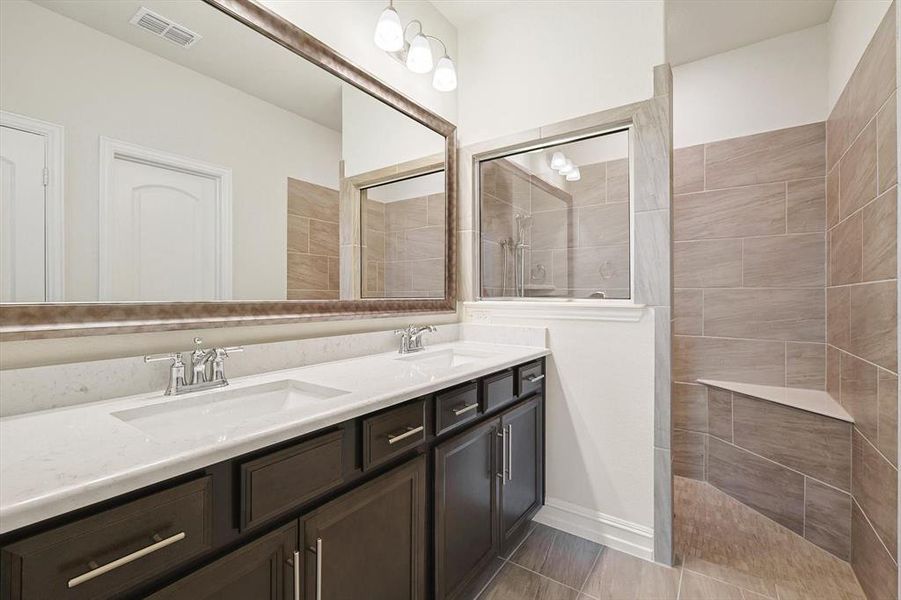 Bathroom with a tile shower and vanity