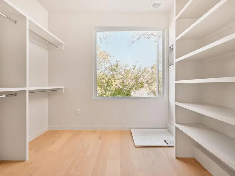 Spacious closet with light wood-style floors