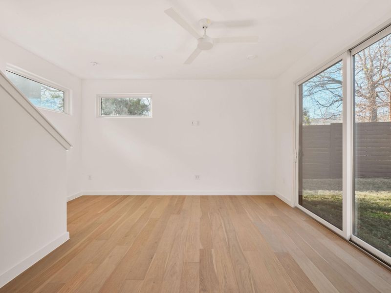Empty room featuring light wood-style floors and ceiling fan