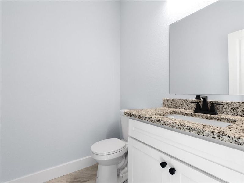 Half bath with vanity and toilet