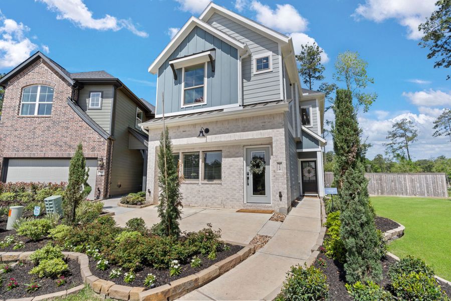 Front exterior of a new home in The Woodlands Hills, Willis, TX, highlighting curb appeal (Image 23).