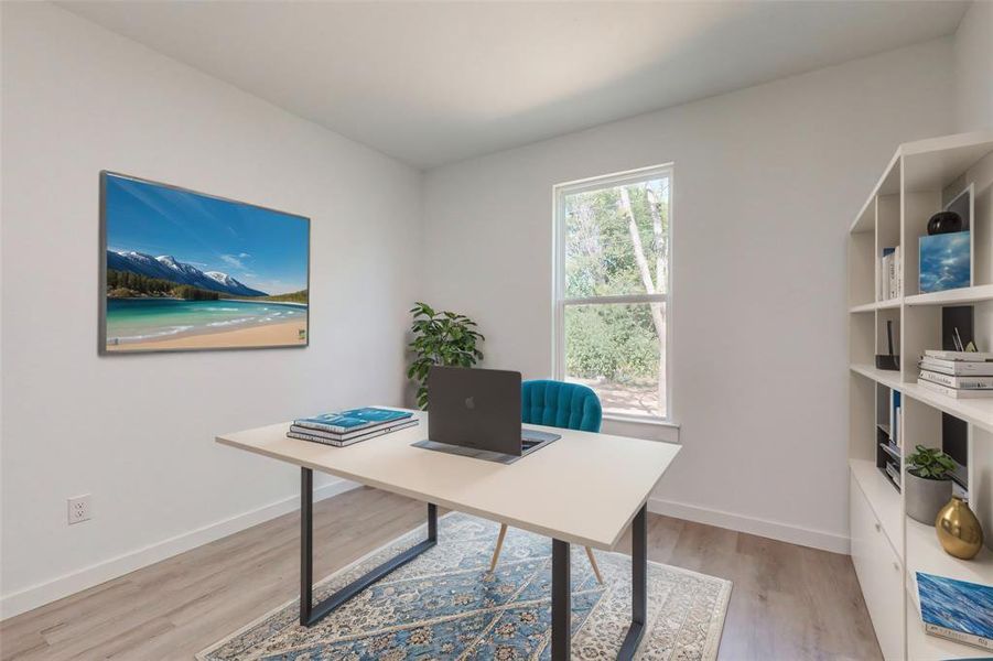 Home office with light hardwood / wood-style floors