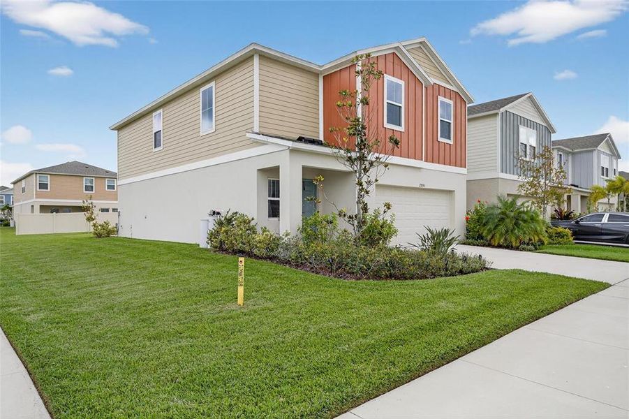 Front exterior of a new home in Hawkstone, Lithia, FL, highlighting curb appeal (Image 30).