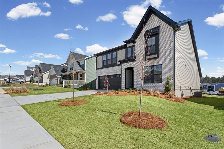 Front exterior of a new home in Twin Lakes, Hoschton, GA, highlighting curb appeal (Image 27). Front exterior of a new home in Twin Lakes, Hoschton, GA, highlighting curb appeal (Image 27).