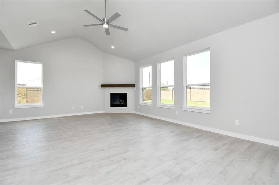 Take another glimpse into the heart of the home with this additional view of the family room—a sprawling space ready to accommodate all your gatherings. Photo shown is example of completed home with similar plan. Actual colors and selections may vary.