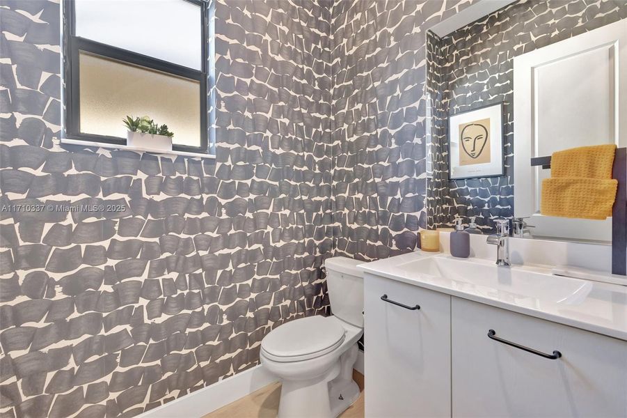 Downstairs powder bathroom located near foyer and garage