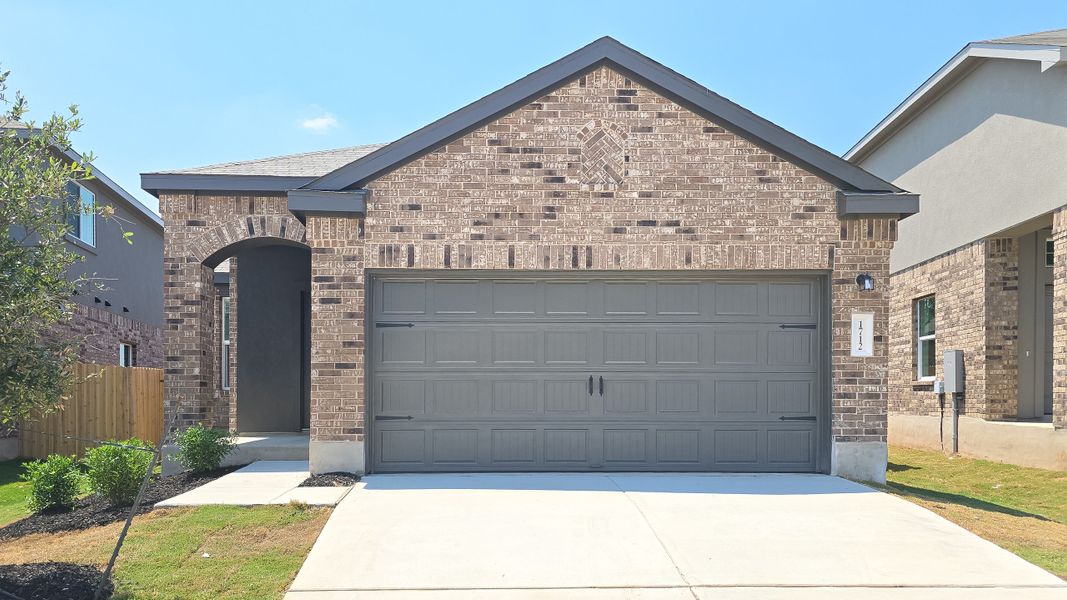 Front exterior of a new home in Woodfield Preserve: Ridgepointe Collection, Georgetown, TX, highlighting curb appeal (Image 1).