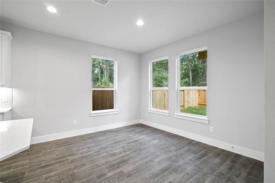 Start your day off right with a cup of coffee sitting with your family in the lovely breakfast nook! Featuring large windows, custom neutral paint, tile flooring, recessed lighting and high ceilings!