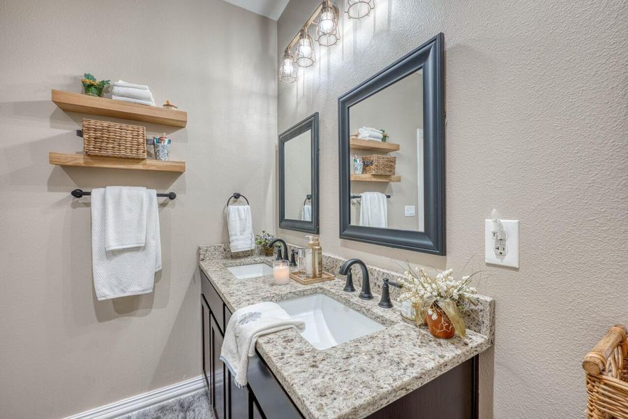 Double vanity with granite countertops, undermount sinks, and matte black fixtures