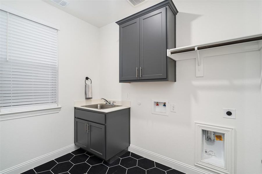 Full size W / D and laundry sink with cabinet and shelving
