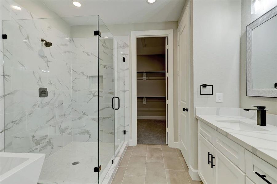 Primary bathroom features freestanding tub, shower, and double sinks for the ultimate spa experience