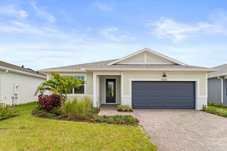 Front exterior of a new home in Tradition - Cadence, Port St. Lucie, FL, highlighting curb appeal (Image 1).