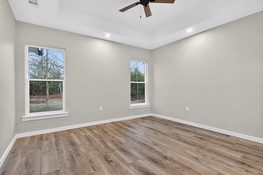 Primary bedroom faces the back of the lot and has wonderful views of the woods and will be perfect for watching the sunrise!
