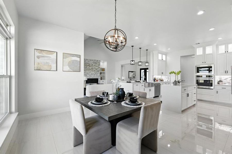 Dining room featuring a chandelier, vaulted ceiling, and recessed lighting Dining room featuring a chandelier, vaulted ceiling, and recessed lighting