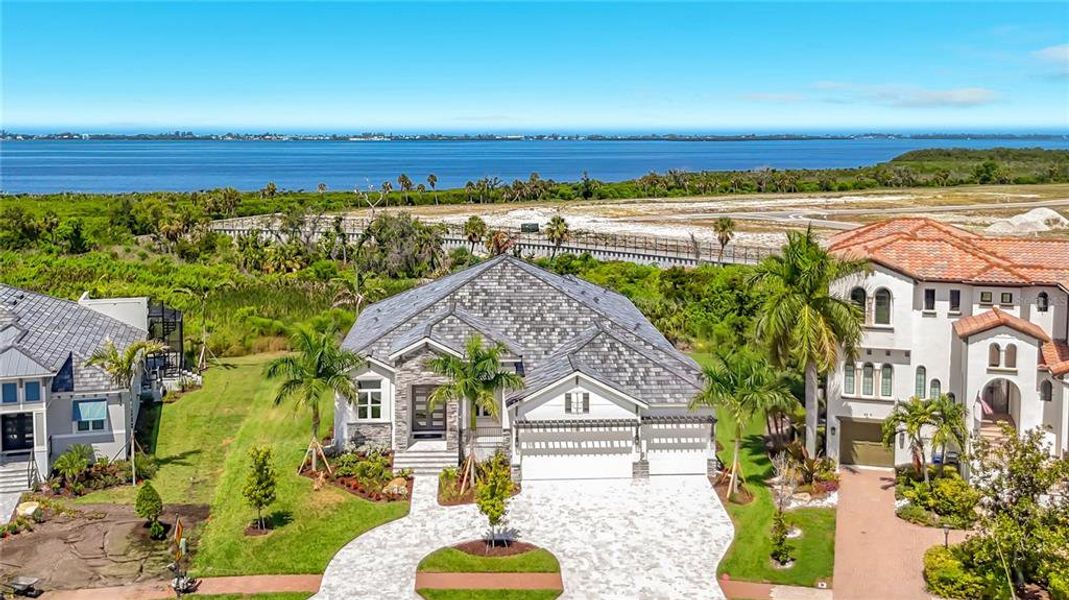Front exterior of a new home in Legends Bay, Bradenton, FL, highlighting curb appeal (Image 2). Front exterior of a new home in Legends Bay, Bradenton, FL, highlighting curb appeal (Image 2).