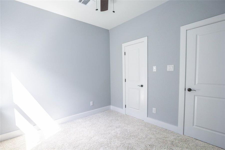 Unfurnished bedroom featuring carpet floors and a ceiling fan