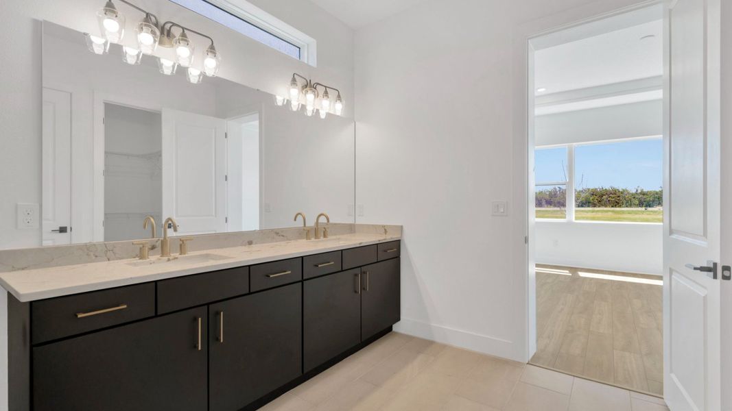 The Primary Bathroom of a DRB Homes Grand Hawk which is offered as a home plan at Serengeti in Spring Hill, FL.