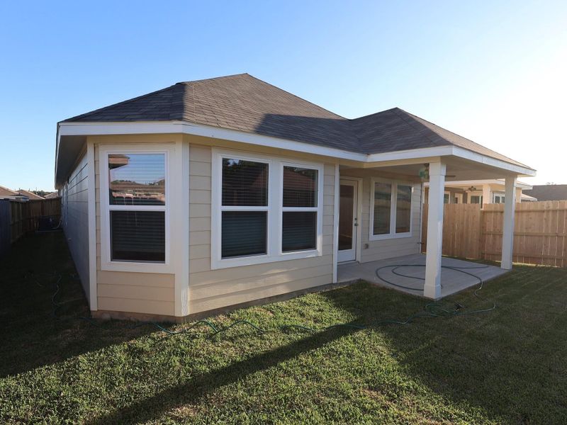 Exterior details and patio area of a home in Pinewood at Grand Texas, New Caney (Image 4).