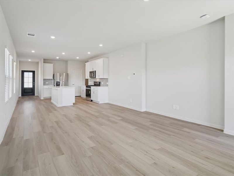 Unfurnished living room with recessed lighting and light wood finished floors