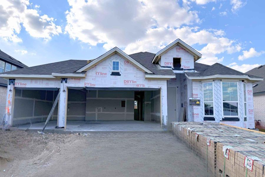 Unfinished property featuring roof with shingles, an attached garage, and driveway Unfinished property featuring roof with shingles, an attached garage, and driveway