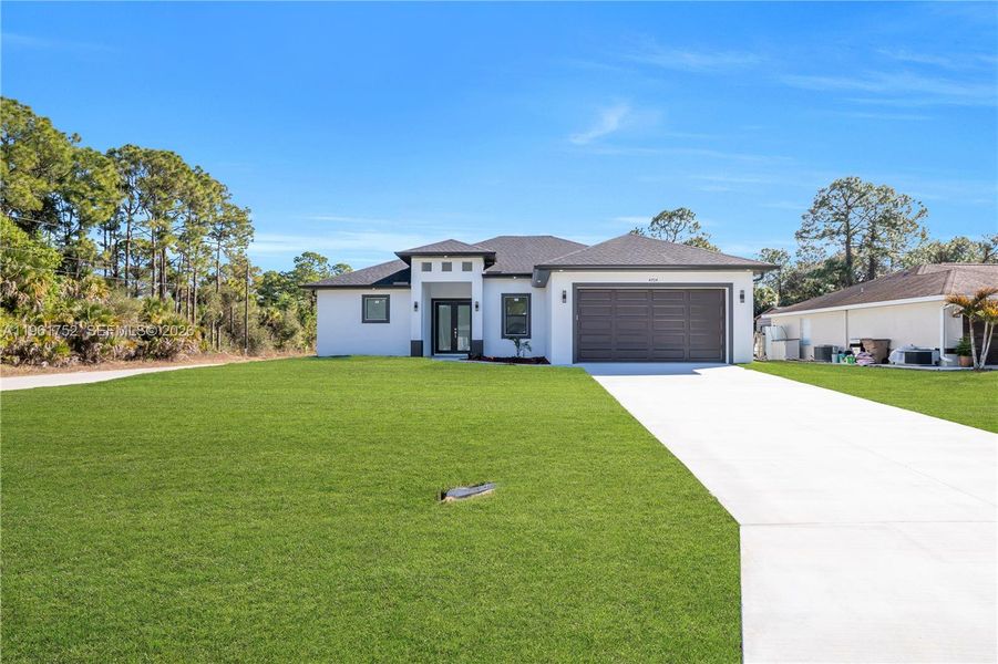 Front exterior of a new home in , Lehigh Acres, FL, highlighting curb appeal (Image 25).