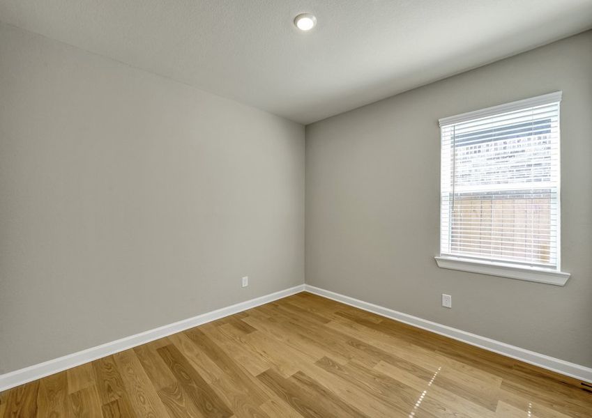 Secondary bedroom featuring wood-look flooring and a window with natural light.