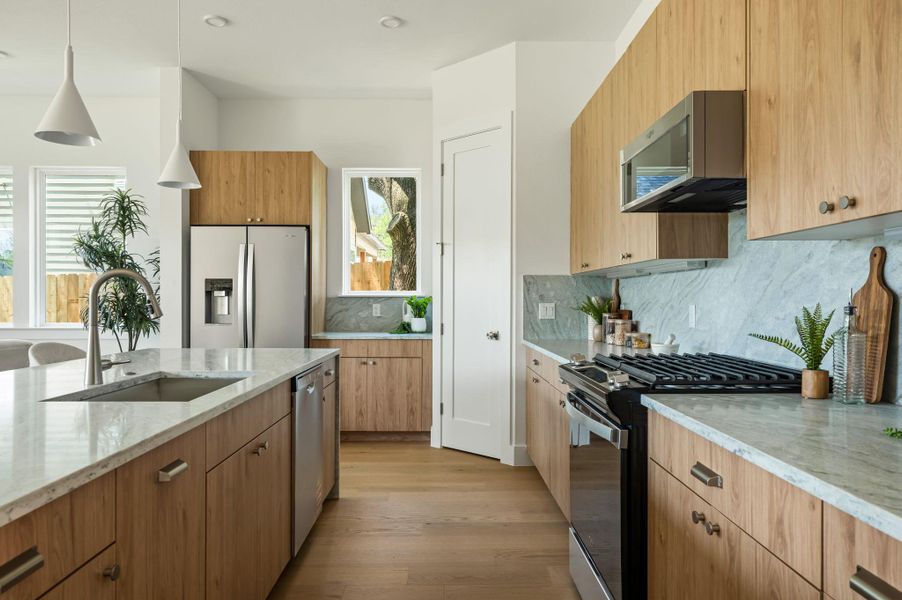 A well-lit kitchen with sleek wooden cabinetry and pristine stone countertops. A well-lit kitchen with sleek wooden cabinetry and pristine stone countertops.