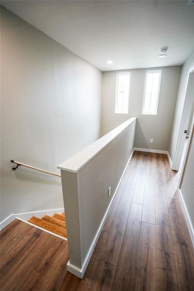 Corridor featuring wood-type flooring