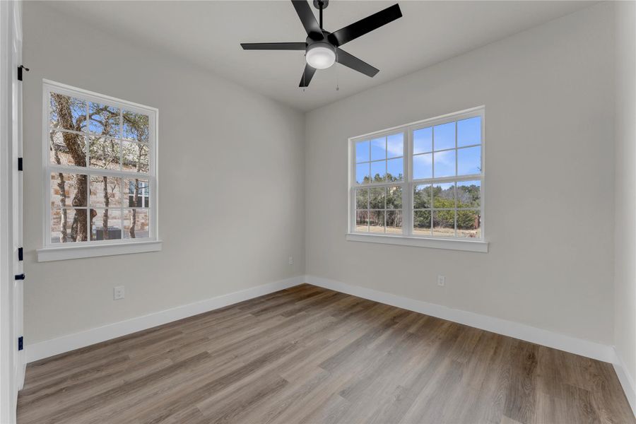 Spare room featuring light wood-style floors and ceiling fan