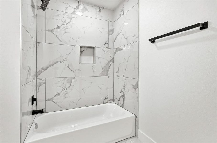 Tub and shower combination featuring large format marble-look tile Tub and shower combination featuring large format marble-look tile