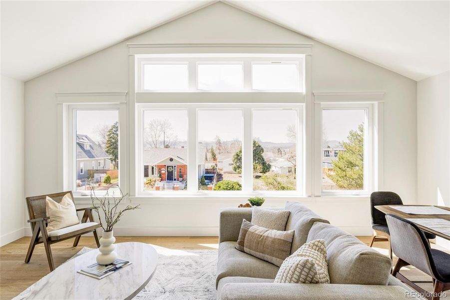 Light-filled great room with vaulted ceilings and expansive windows with mountain views