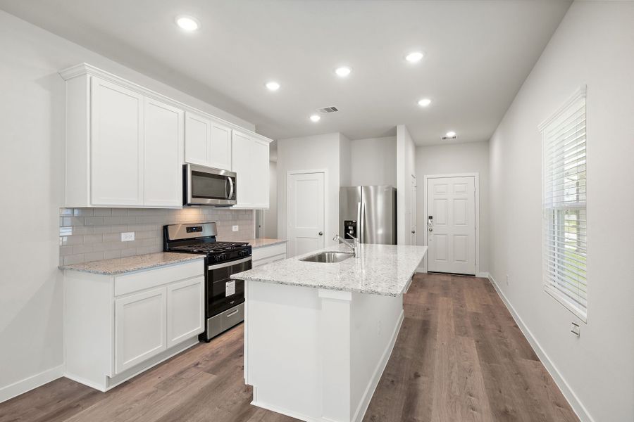 A kitchen with white cabinets. A kitchen with white cabinets.