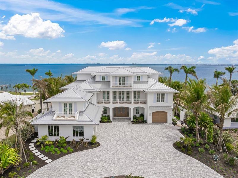 Front exterior of a new home in , Holmes Beach, FL, highlighting curb appeal (Image 26). Front exterior of a new home in , Holmes Beach, FL, highlighting curb appeal (Image 26).