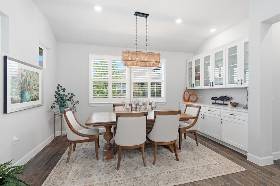 The dining room is adjacent to the kitchen and is within steps of the family room. A wall of custom built-ins along one wall has upper and lower cabinets for storage and serving. The windows overlook the landscaped backyard. The dining room is adjacent to the kitchen and is within steps of the family room. A wall of custom built-ins along one wall has upper and lower cabinets for storage and serving. The windows overlook the landscaped backyard.