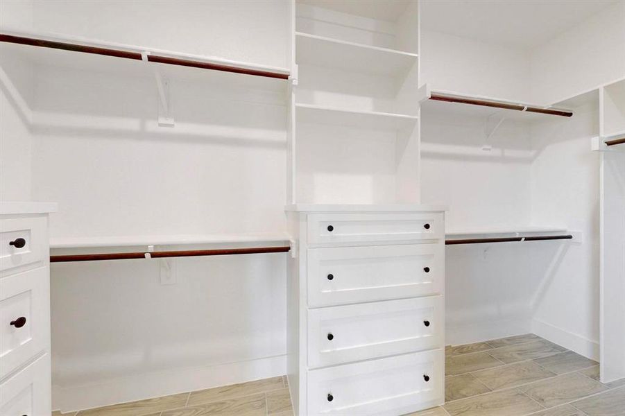 Spacious closet with wood tiled floor