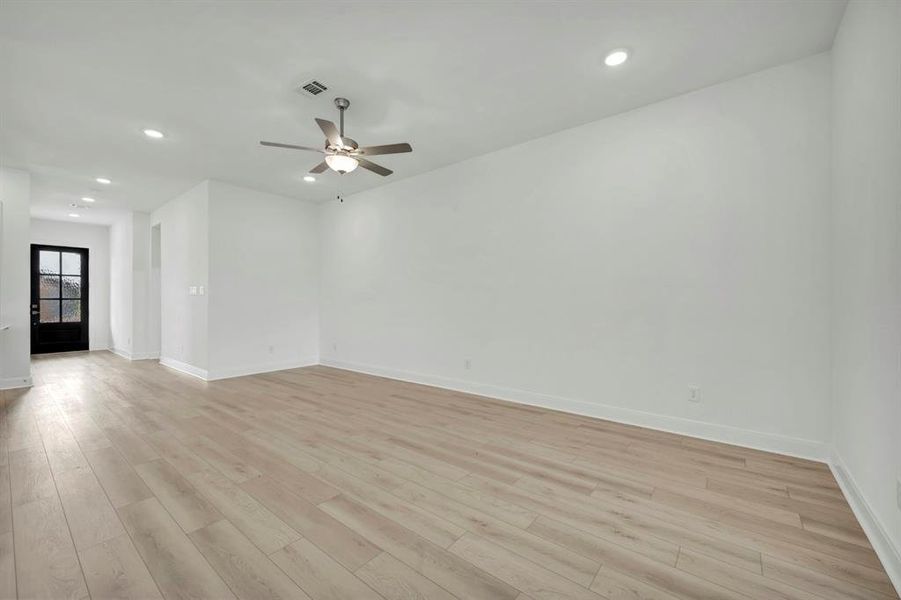 Spare room featuring recessed lighting, a ceiling fan, and light wood-style floors Spare room featuring recessed lighting, a ceiling fan, and light wood-style floors
