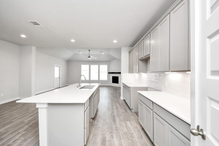 As it all unfolds, the kitchen opens up to the expansive family room, creating a perfect hub for gatherings and making every meal a social event. As it all unfolds, the kitchen opens up to the expansive family room, creating a perfect hub for gatherings and making every meal a social event.