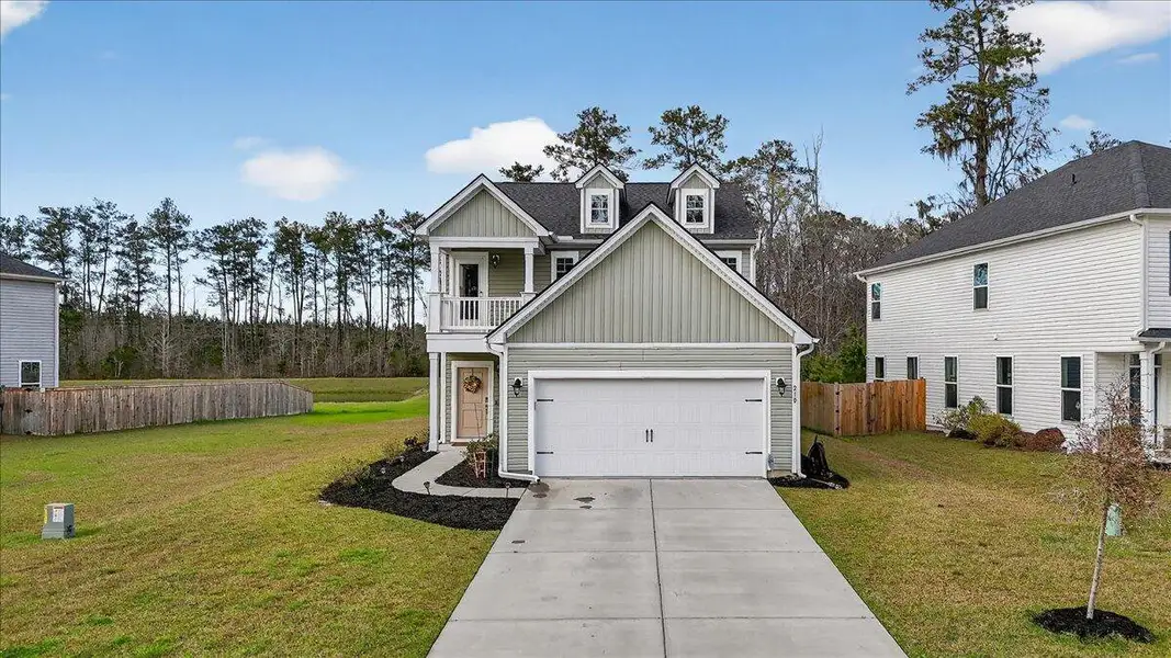 Front exterior of a new home in Jasmine Point at Lakes of Cane Bay, Summerville, SC, highlighting curb appeal (Image 2).