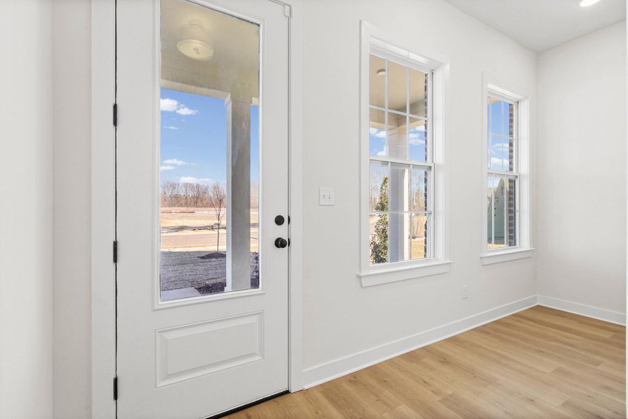 Entryway featuring baseboards and wood finished floors Entryway featuring baseboards and wood finished floors