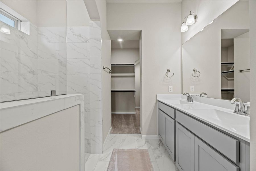 Spacious primary bathroom with beautiful extra large glass shower.