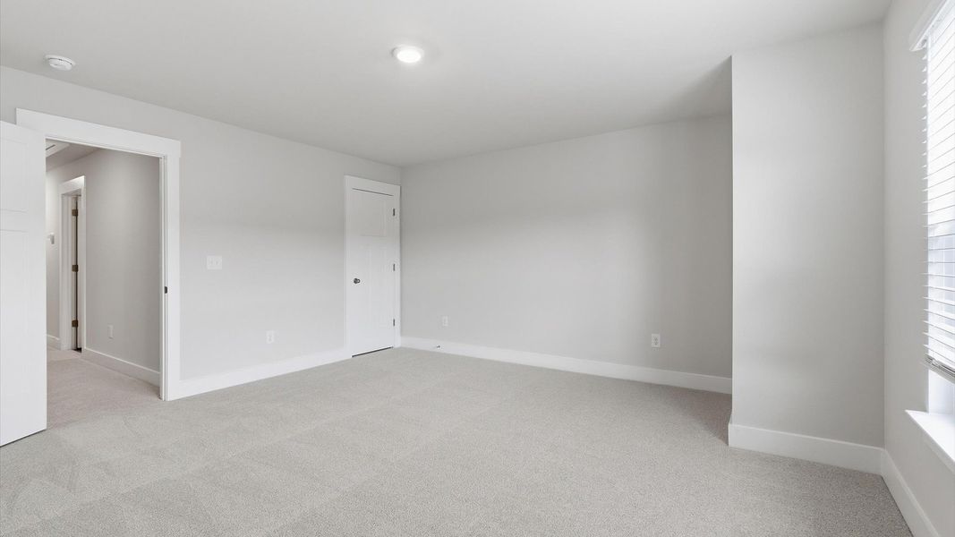 Elegant bedroom retreat featuring soft carpeting and a thoughtfully designed walk-in closet in Anderson, SC Elegant bedroom retreat featuring soft carpeting and a thoughtfully designed walk-in closet in Anderson, SC