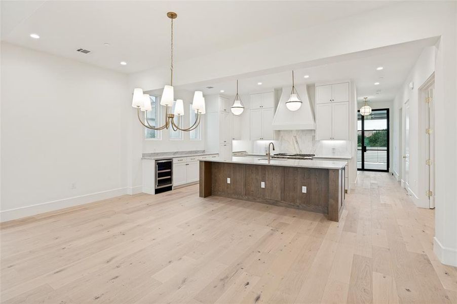 A grand open living space with an oversized island creates effortless flow for entertaining