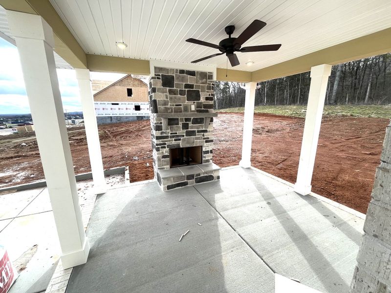Outdoor covered patio with wood burning fireplace