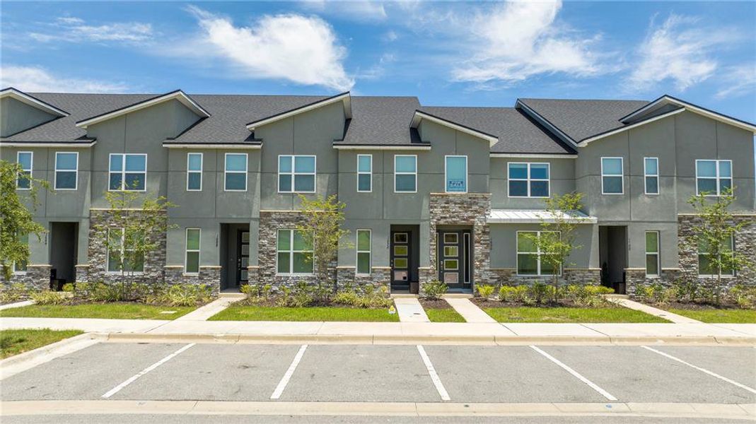 Front exterior of a new home in Solara Resort, Kissimmee, FL, highlighting curb appeal (Image 18).